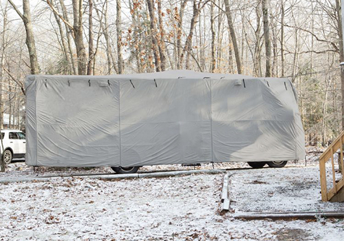 image of RV with cover in snow